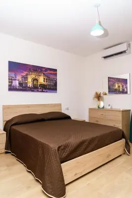 a bedroom with a large bed in a room at DIMORA SAITTA per SAITTA HOLIDAYS in Palermo