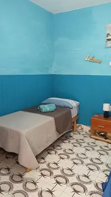 a bedroom with two beds and a blue wall at LA TERRAZZA SUL MARE camera doppia vicino aereoporto&mare SICILIAN SEA STYLE ROOM in Cinisi