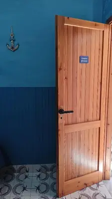 a wooden door with a sign on it in a room at LA TERRAZZA SUL MARE camera doppia vicino aereoporto&mare SICILIAN SEA STYLE ROOM in Cinisi