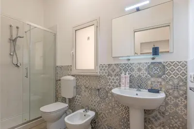 a bathroom with a sink and a toilet and a shower at La casa sul Mercato by Wonderful Italy in Palermo