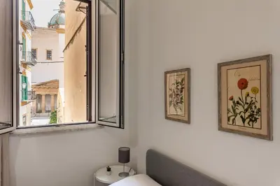 a bathroom with two windows and a toilet at La casa sul Mercato by Wonderful Italy in Palermo