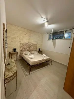 a bedroom with a bed and a brick wall at Mondello Telemaco Beach in Palermo