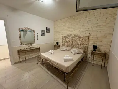a bedroom with a bed with a mirror and a dresser at Mondello Telemaco Beach in Palermo