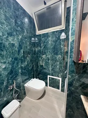 a bathroom with a toilet and a tv on the wall at Mondello Telemaco Beach in Palermo