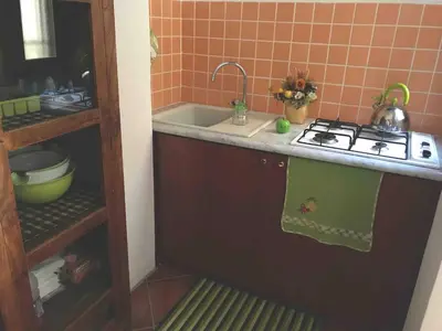 a kitchen with a sink and a stove top oven at Little house of Grandpa Antonio in Palermo