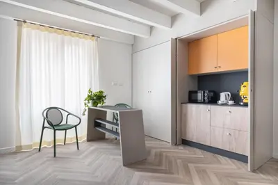 a kitchen with a desk and a chair in a room at La Terrazza su Dante Rooms in Palermo