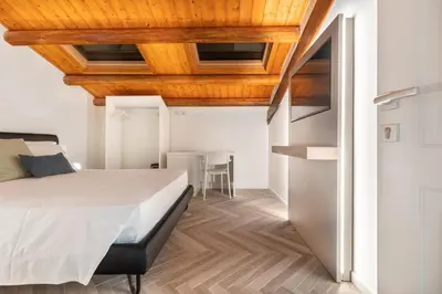 a bedroom with a bed and a wooden ceiling at La Terrazza su Dante Rooms in Palermo