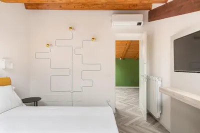 a bedroom with a bed and a flat screen tv at La Terrazza su Dante Rooms in Palermo