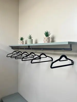 a shelf with glasses and potted plants on a wall at Cathedral Room&Loft in Palermo