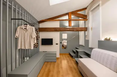 a living room with gray and white walls at Cathedral Room&Loft in Palermo