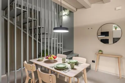 a dining room with a table and chairs at Cathedral Room&Loft in Palermo