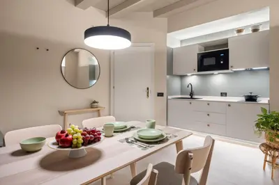 a kitchen and dining room with a table and chairs at Cathedral Room&Loft in Palermo