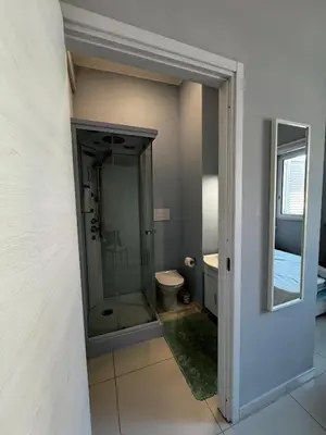 a bathroom with a glass shower and a toilet at La Piazzetta a Mare Holiday House in Sferracavallo