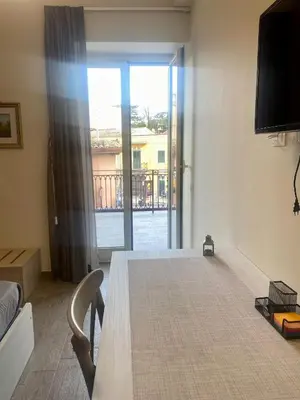 a room with a table and a view of a balcony at De Luca in Palermo