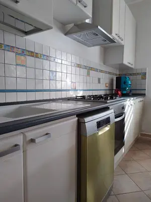 a kitchen with white cabinets and a stainless steel dishwasher at D'Amelio Sweet Home in Palermo