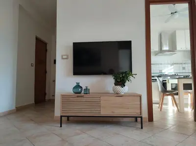 a living room with a tv on a wall at D'Amelio Sweet Home in Palermo