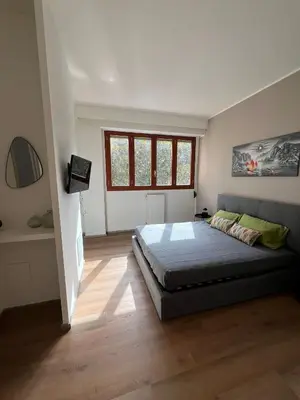 a bedroom with a large bed and a window at LaPignaVerde in Palermo