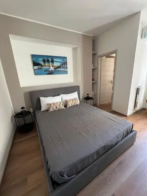 a bedroom with a large bed in a room at LaPignaVerde in Palermo