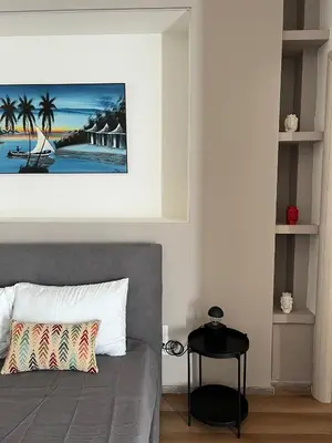 a bedroom with a bed with a painting on the wall at LaPignaVerde in Palermo