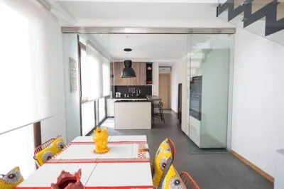 a kitchen and dining room with a table and chairs at iFlat Corte Seralcadi in Palermo