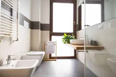 a bathroom with a sink and a toilet and a mirror at iFlat Corte Seralcadi in Palermo