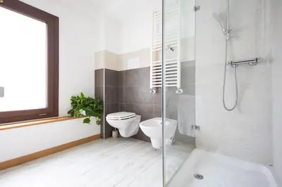 a bathroom with a shower and a toilet and a sink at iFlat Corte Seralcadi in Palermo