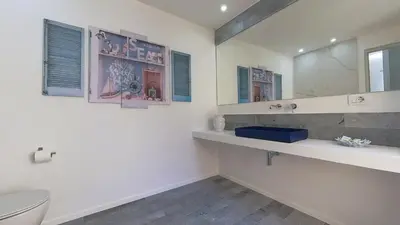 a bathroom with a toilet and a sink and a mirror at Casa Degli Aragonesi in Palermo