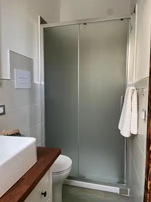 a bathroom with a shower with a toilet and a sink at Casa vacanze green house in Terrasini