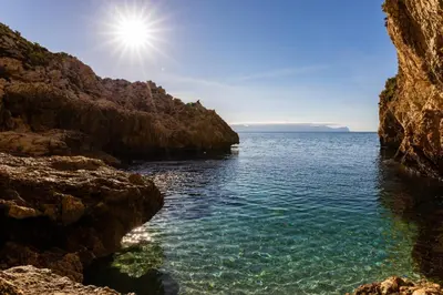 a view of the ocean from a rocky cliff at Casa vacanze green house in Terrasini