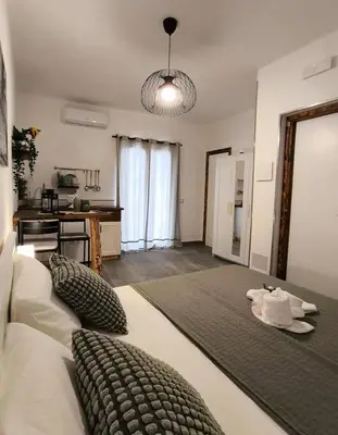 a large room with a bed and a table at Casa vacanze green house in Terrasini