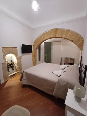 a bedroom with a large bed in a room at Residenza del Massimo in Palermo