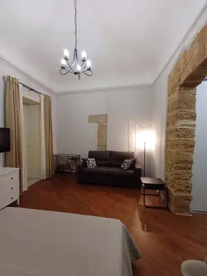 a living room with a couch and a table at Residenza del Massimo in Palermo