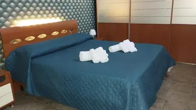 a bedroom with a blue bed with towels on it at Casa Patry in Palermo