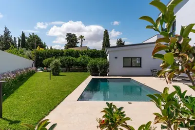 a backyard with a swimming pool and a house at Villa Tina Mondello in Mondello