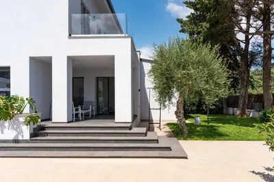 a white house with stairs and trees at Villa Tina Mondello in Mondello