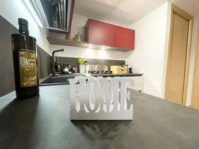 a wine bottle and a sign on a counter in a kitchen at I due archi in Bagheria