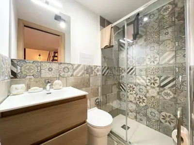 a bathroom with a shower and a toilet and a sink at I due archi in Bagheria