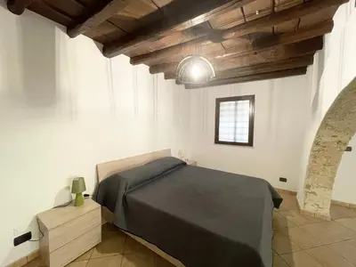 a bedroom with a bed in a room with wooden ceilings at I due archi in Bagheria