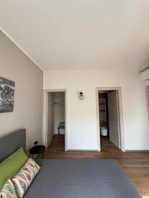 a living room with a couch and a room at LaPignaVerde Suites in Palermo