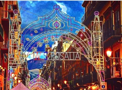 a street with an arch with christmas lights at 145 Maqueda Palermo in Palermo