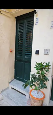 a potted plant sitting in front of a green door at Teresita in Monreale