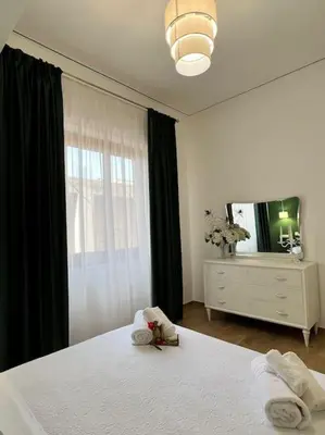 a bedroom with a bed and a dresser and a mirror at Casa Vacanze Tirreno in Trabia