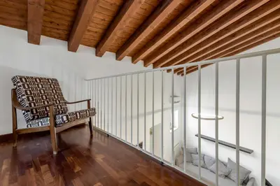 a bench in a room with a wooden ceiling at GuestHost - Vucciria & La Cala Lovely Apartment with Terrace in Palermo