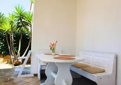 a white table and chairs in a room at Villa Giorgia in Alcamo