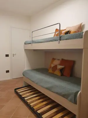 a room with two bunk beds with pillows on them at Villa Regina ai Faraglioni di Scopello in Scopello
