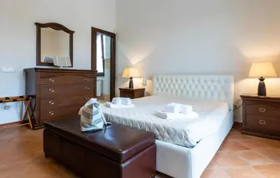 a bedroom with a bed with a dresser and a mirror at Cozy Home In Partinico in Partinico