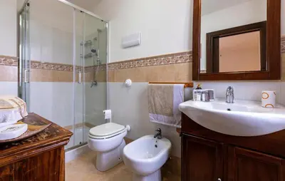 a bathroom with a sink and a toilet and a shower at Cozy Home In Partinico in Partinico