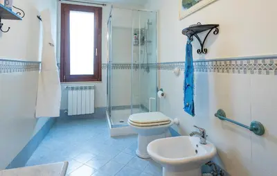 a bathroom with a toilet and a shower and a sink at Cozy Home In Partinico in Partinico