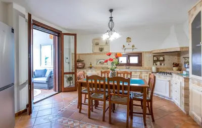 a kitchen with a dining room table and chairs at Cozy Home In Partinico in Partinico