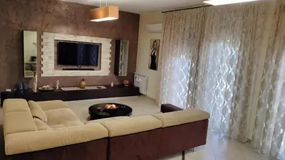a living room with a couch and a tv at Casa Stella in Palermo